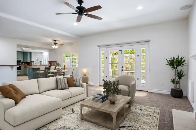 a living room with furniture potted plant and a window