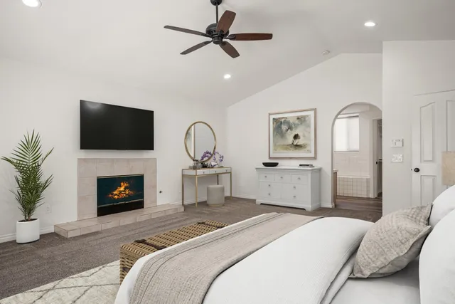 a bedroom with a bed and a fireplace