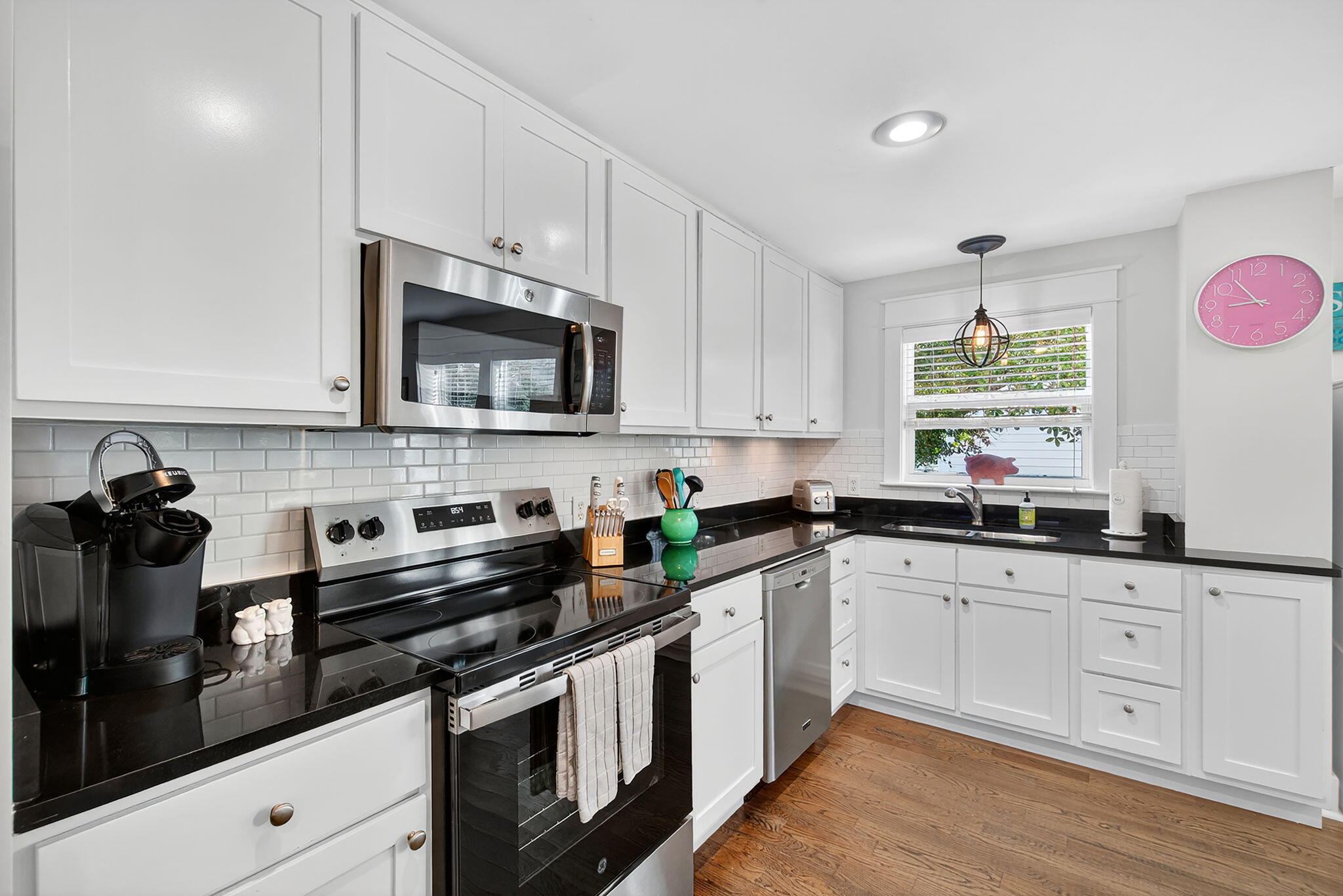 335 San Juan Avenue Santa Rosa Beach, FL 32459 - Photo 12 of 39 a kitchen with stainless steel appliances white cabinets and a sink