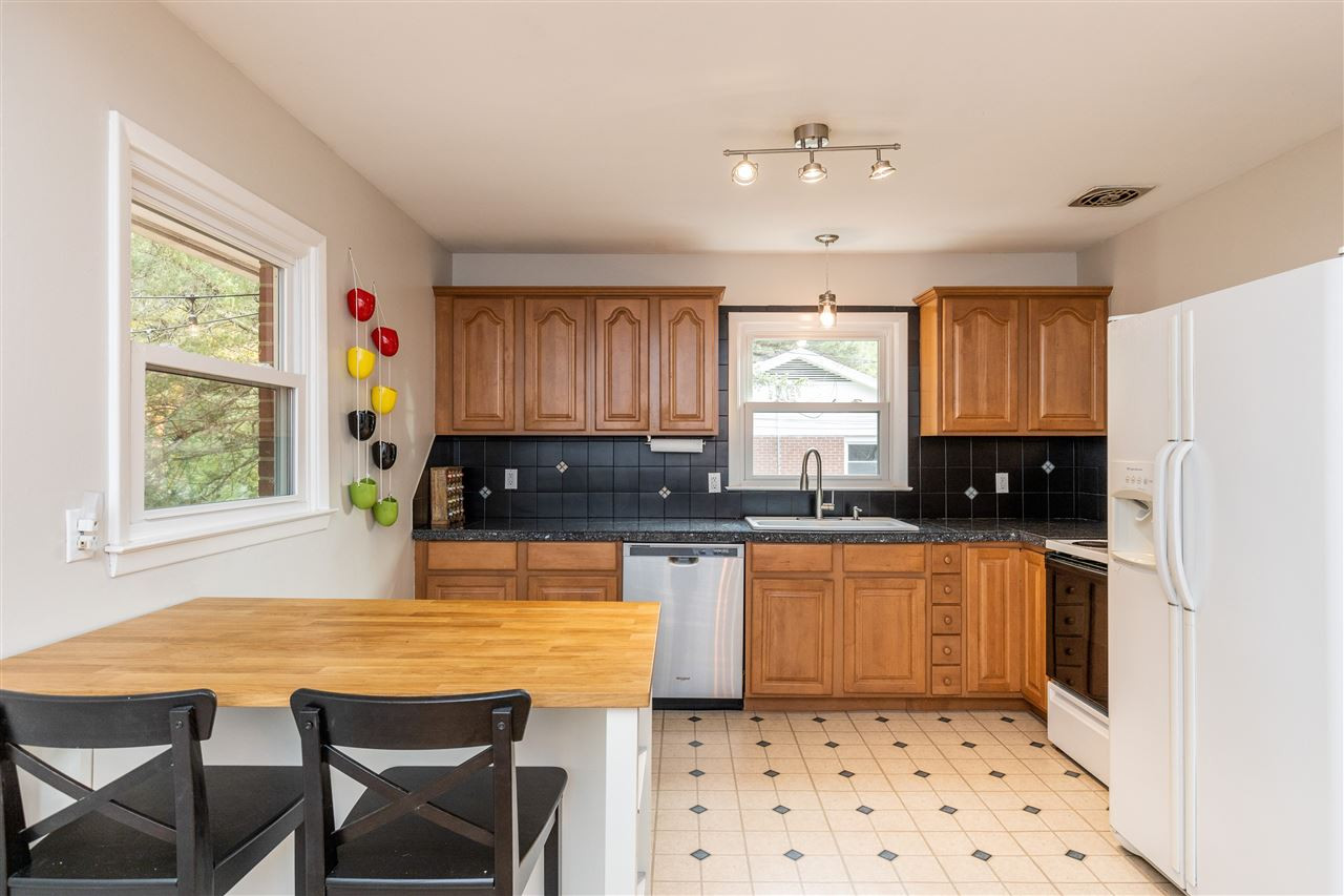 103 Crest Road Cary, NC 27513 - Photo 11 of 30 Kitchen island with room for two barstools and two shelves of storage on other side. Kitchen
