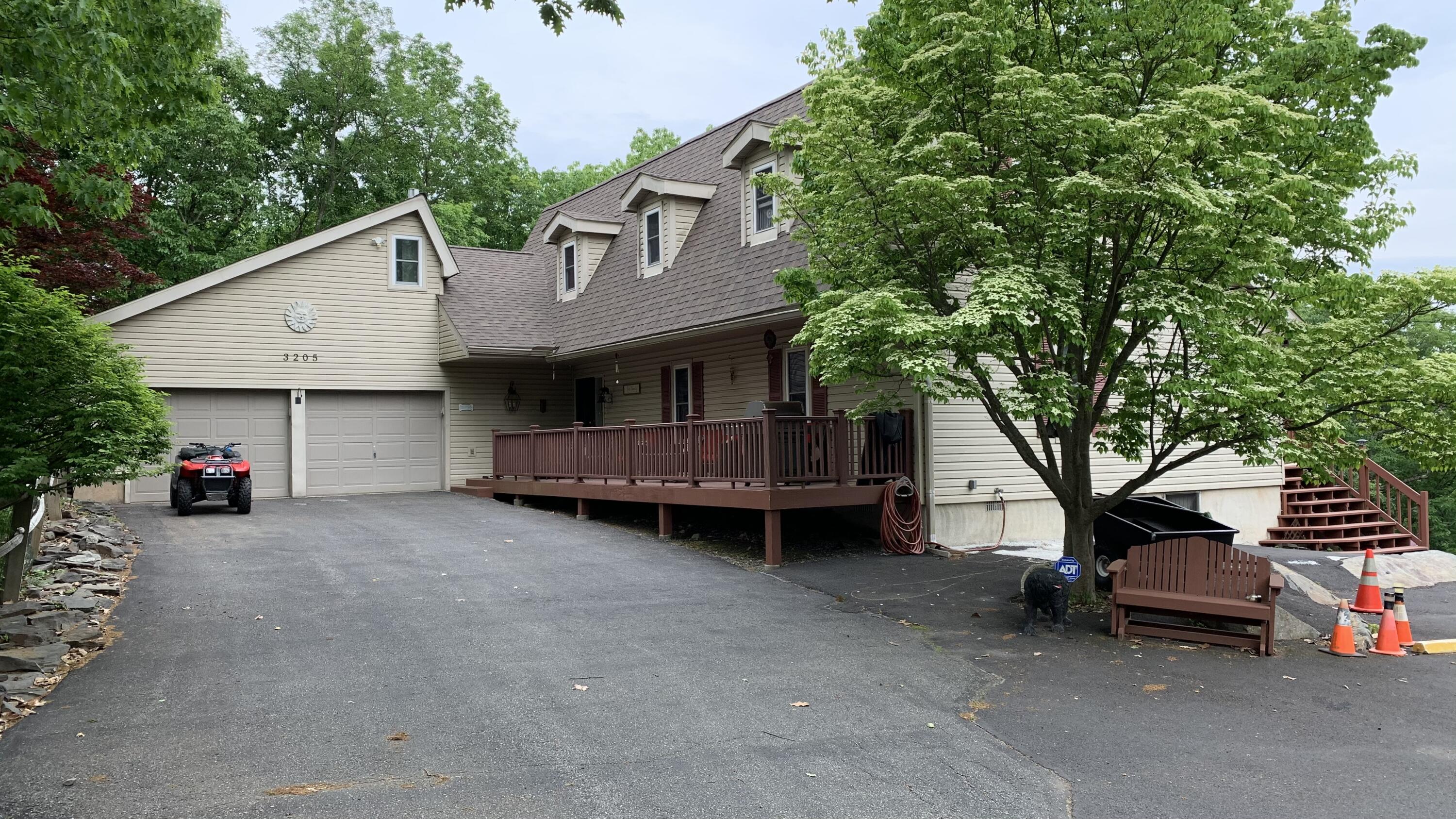 a view of a house with a yard and sitting area