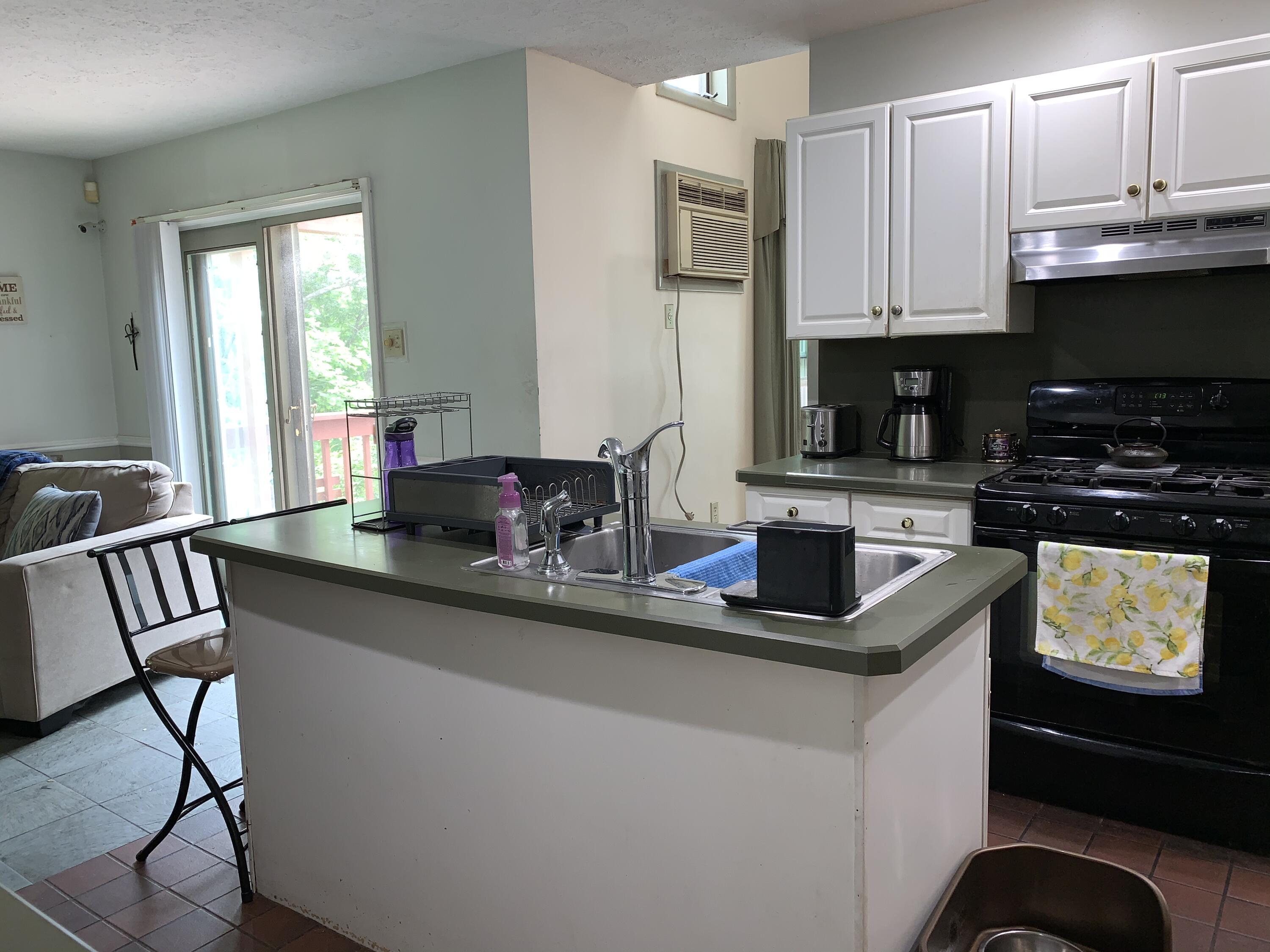 3205 Ely Court Bushkill, PA 18324 - Photo 19 of 80 a kitchen with stainless steel appliances a sink a stove a refrigerator cabinets and a dining table