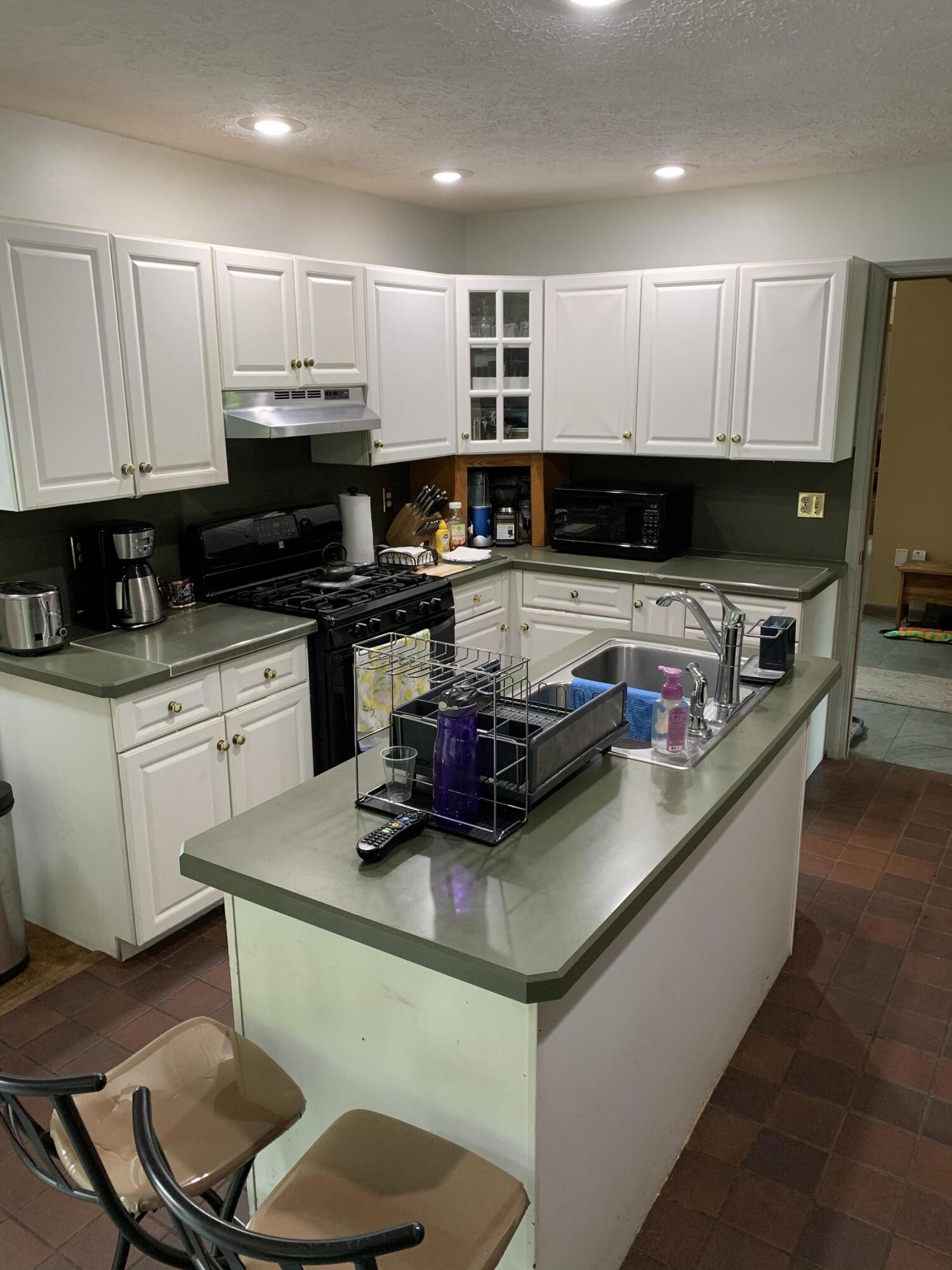 3205 Ely Court Bushkill, PA 18324 - Photo 21 of 80 a kitchen with kitchen island granite countertop a sink a stove cabinets and a counter top space