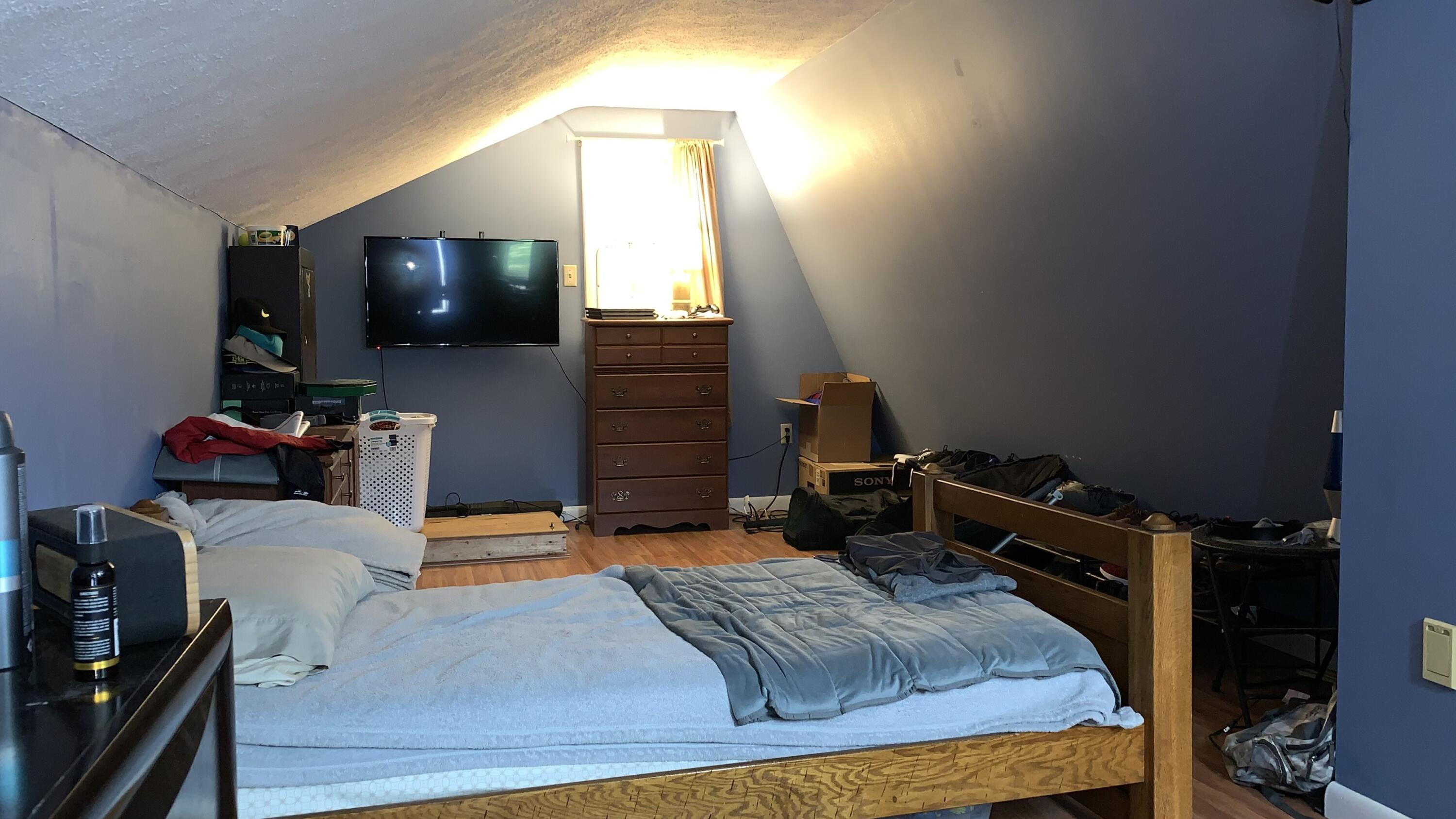 3205 Ely Court Bushkill, PA 18324 - Photo 47 of 80 a bedroom with a bed and a flat tv screen on the dresser
