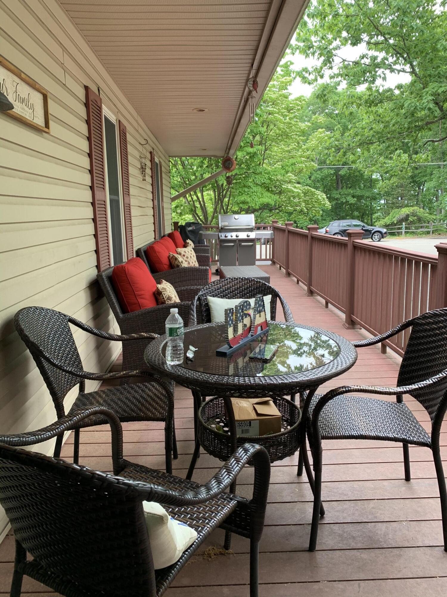 3205 Ely Court Bushkill, PA 18324 - Photo 52 of 80 a view of a patio with table and chairs with wooden floor and fence