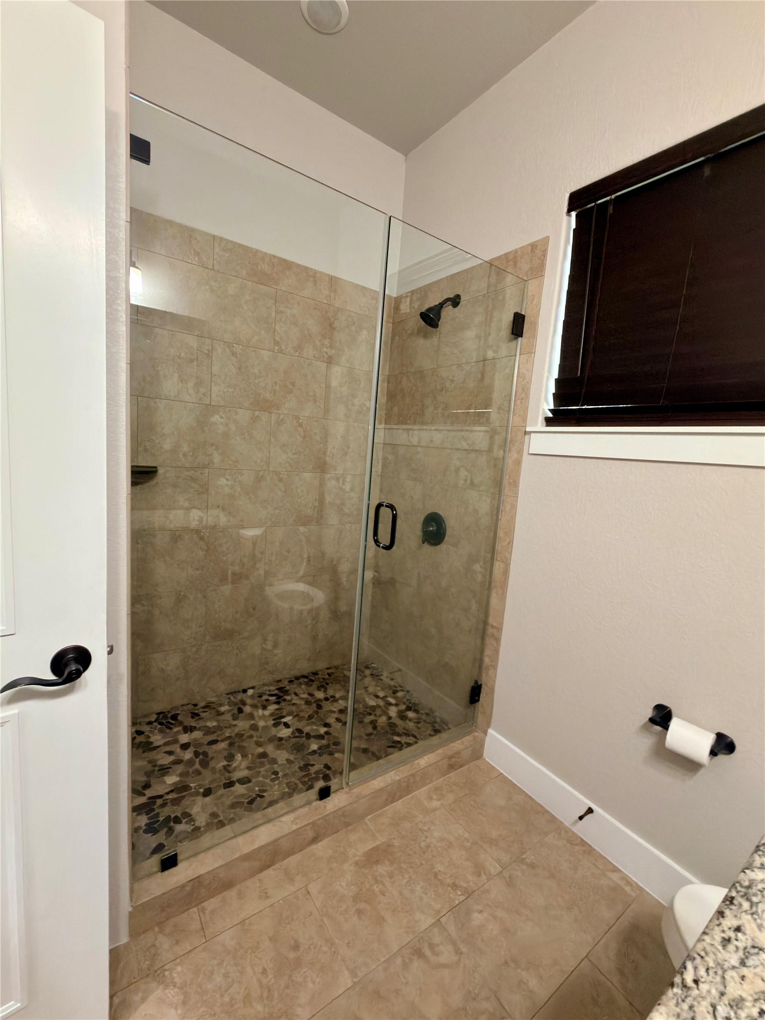 127 Comanche Trail, Unit A Elgin, TX 78621 - Photo 17 of 33 Full bath featuring a stall shower and light tile patterned floors