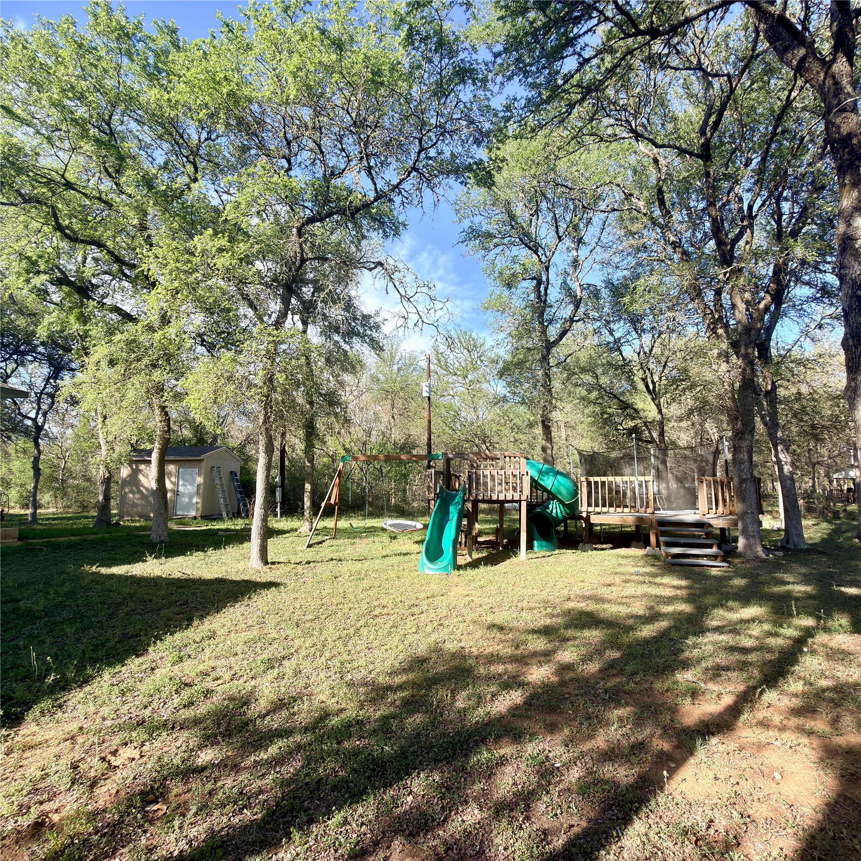 127 Comanche Trail, Unit A Elgin, TX 78621 - Photo 29 of 33 View of grassy yard with a wooden deck