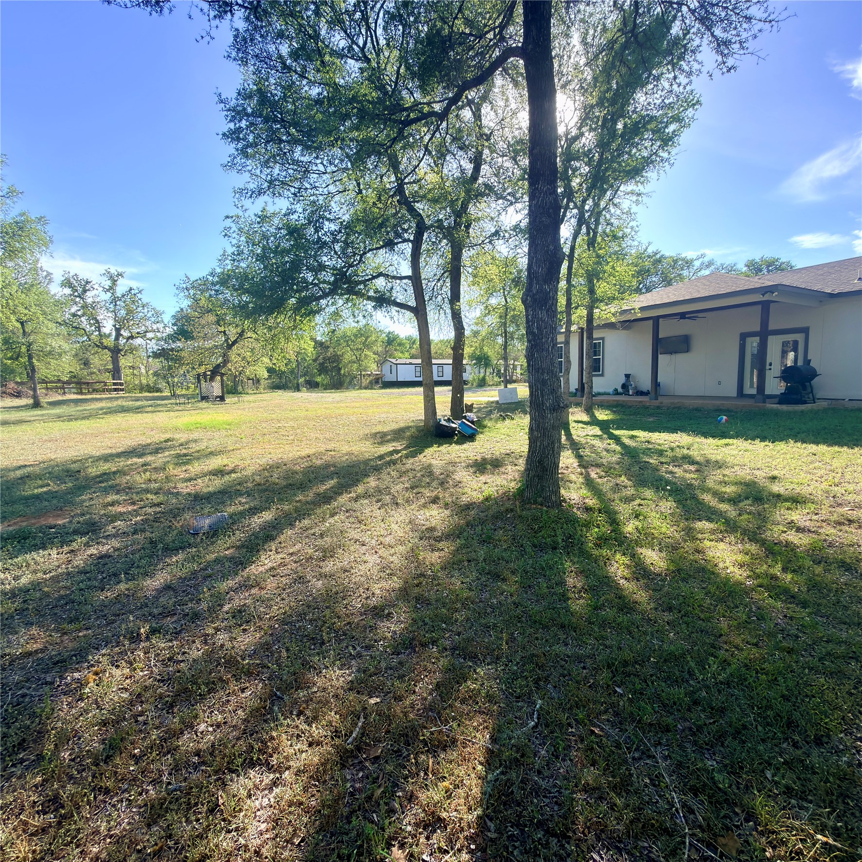 127 Comanche Trail, Unit A Elgin, TX 78621 - Photo 32 of 33 View of grassy yard featuring a patio