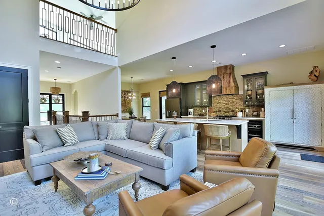 a kitchen with stainless steel appliances granite countertop a sink a stove and cabinets