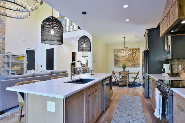 a kitchen with stainless steel appliances a sink stove and cabinets