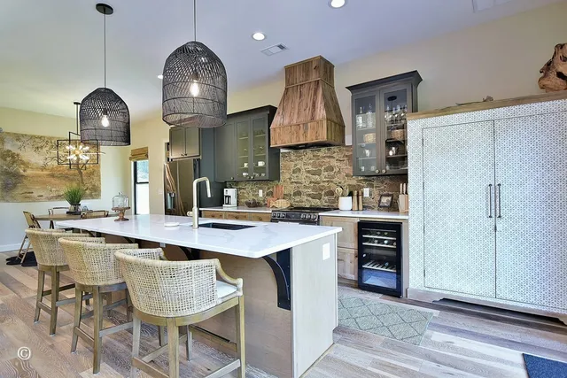 a dining room with furniture a chandelier and wooden floor