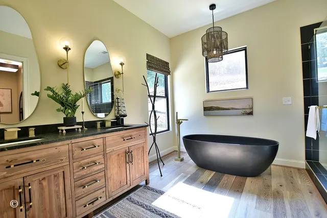 a bathroom with a toilet and a painting on the wall