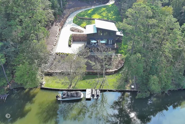 an aerial view of a house with a yard