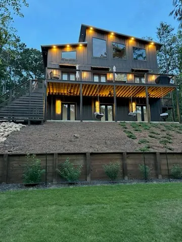 an aerial view of house with yard swimming pool and outdoor seating