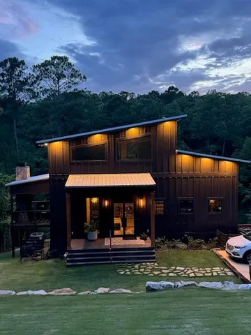 a view of a house with a swimming pool and a yard