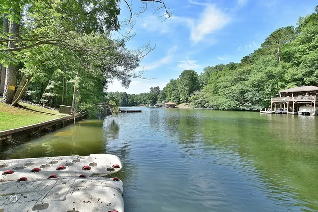 a living room with furniture kitchen view and large windows