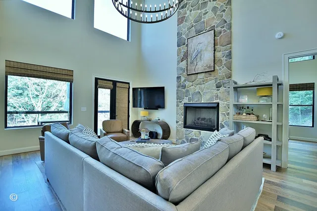 a living room with furniture kitchen view and a table