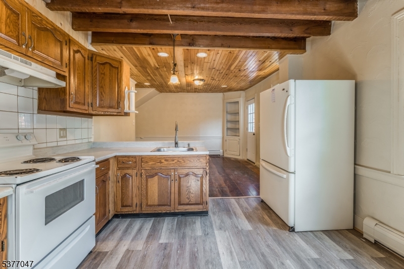 7080 Lt York-mtpleasant Milford, NJ 08848 - Photo 6 of 30 a kitchen with a refrigerator a sink and wooden floor