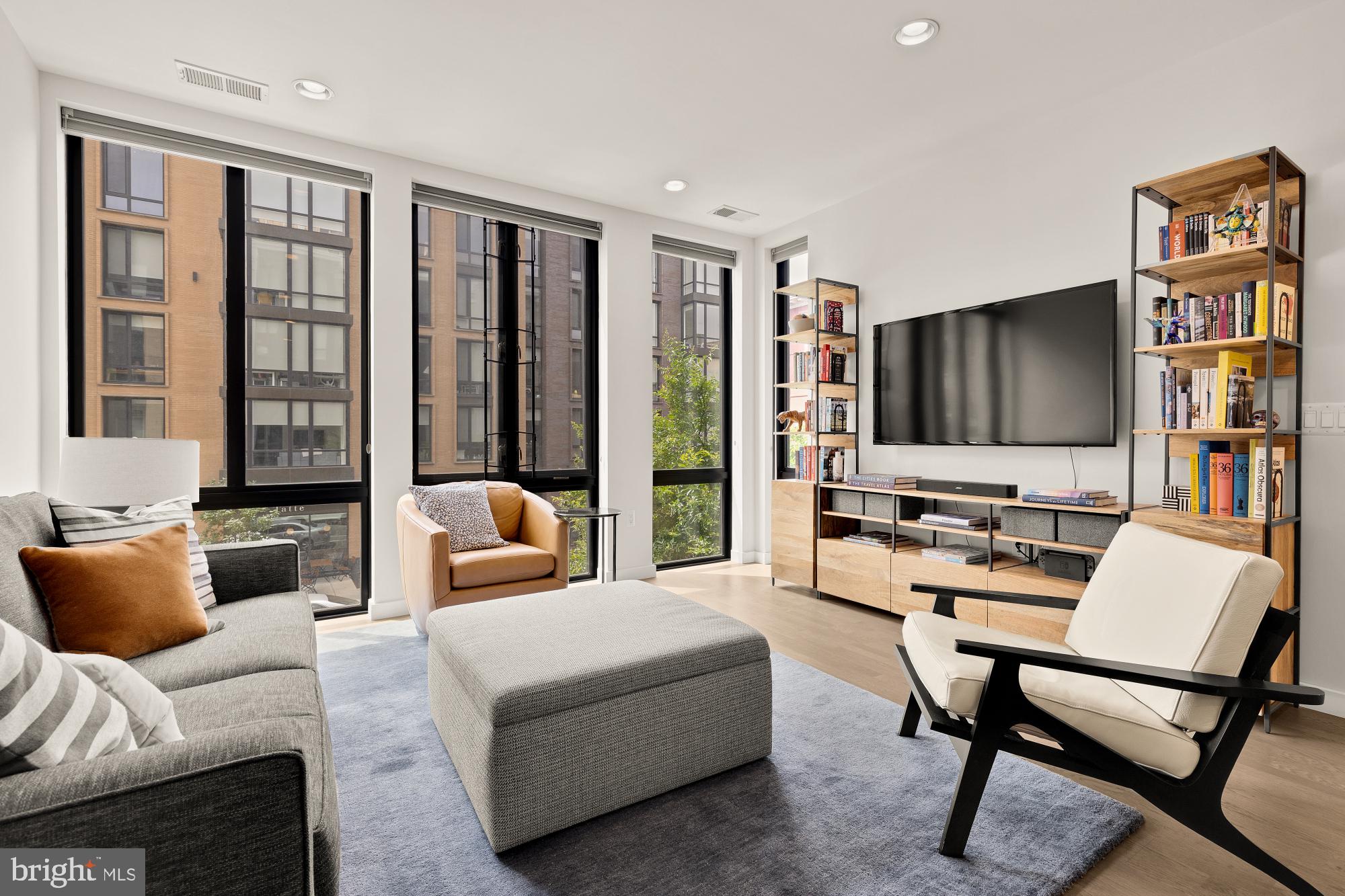 a bedroom with furniture and a flat screen tv