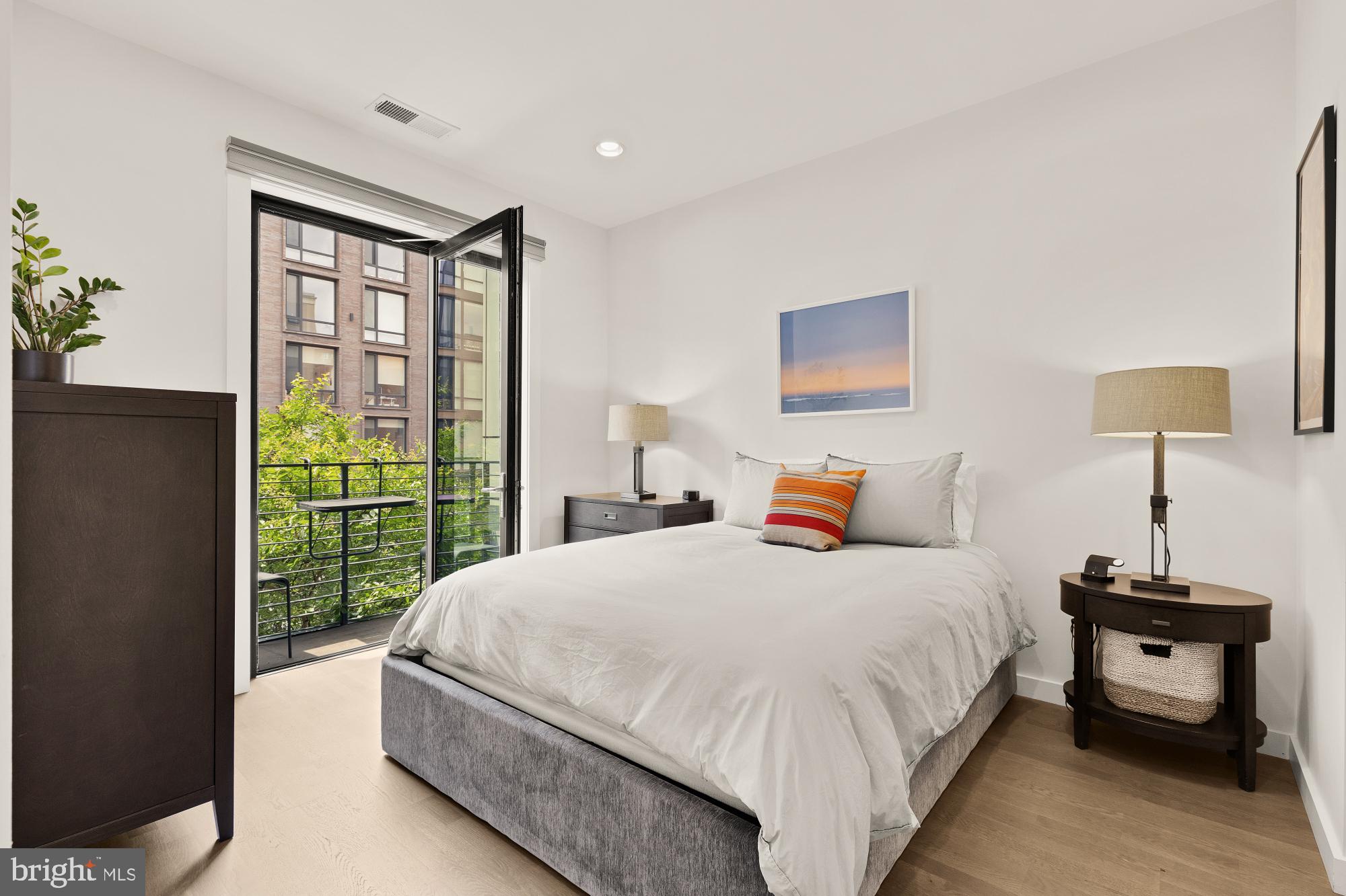 1405 W Street Northwest, Unit 203 Washington, DC 20009 - Photo 11 of 20 a bedroom with a bed and a window