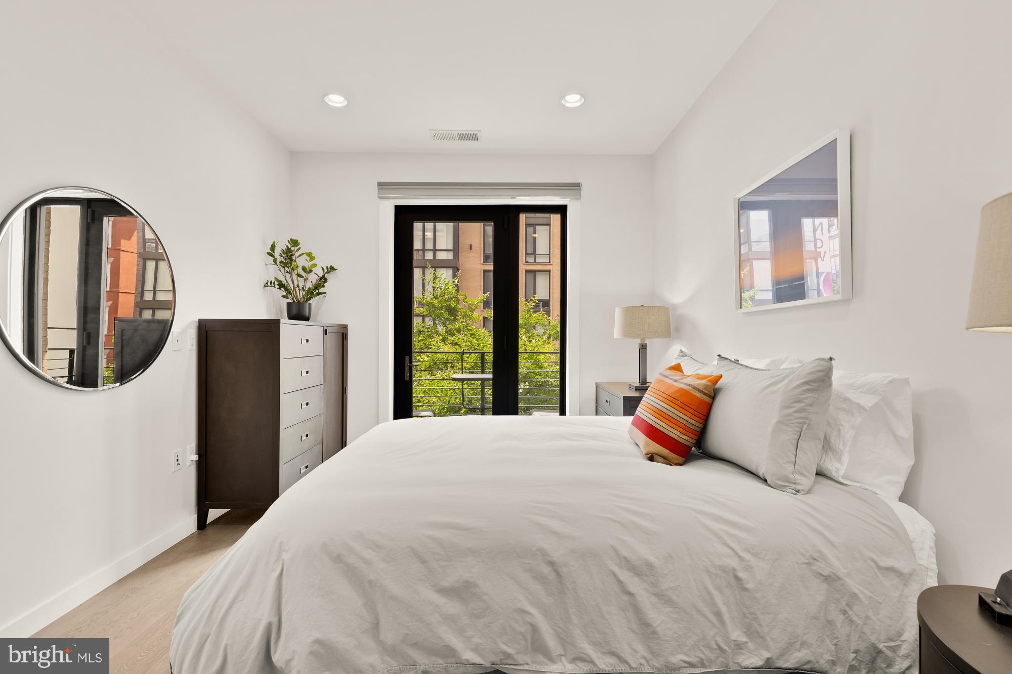 1405 W Street Northwest, Unit 203 Washington, DC 20009 - Photo 12 of 20 a bedroom with a bed and a large window