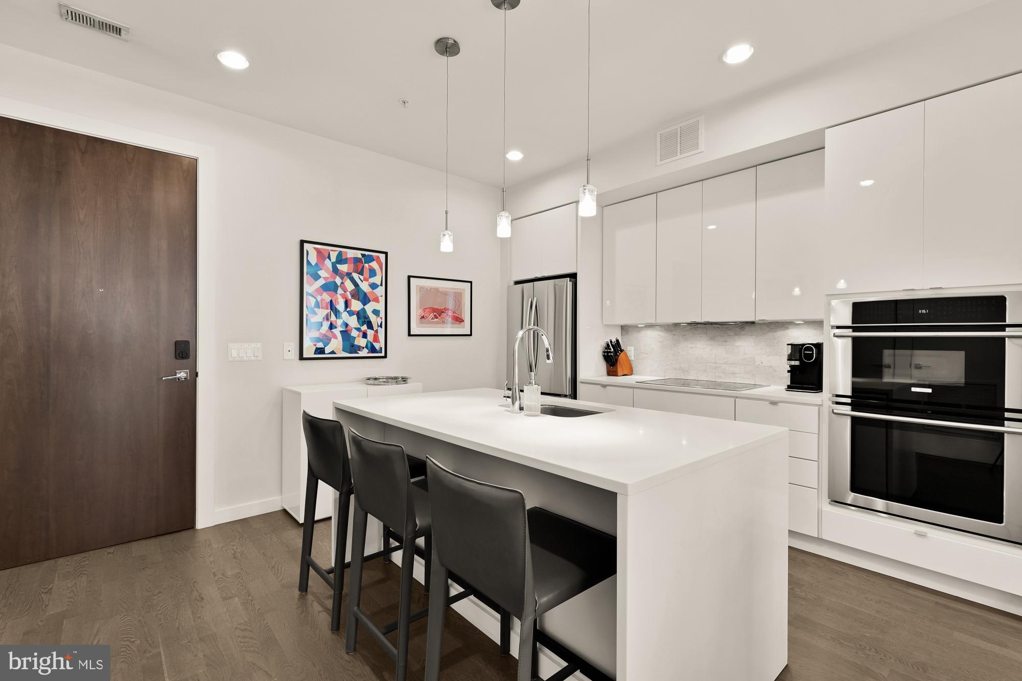 1405 W Street Northwest, Unit 203 Washington, DC 20009 - Photo 3 of 20 a kitchen with a table and chairs