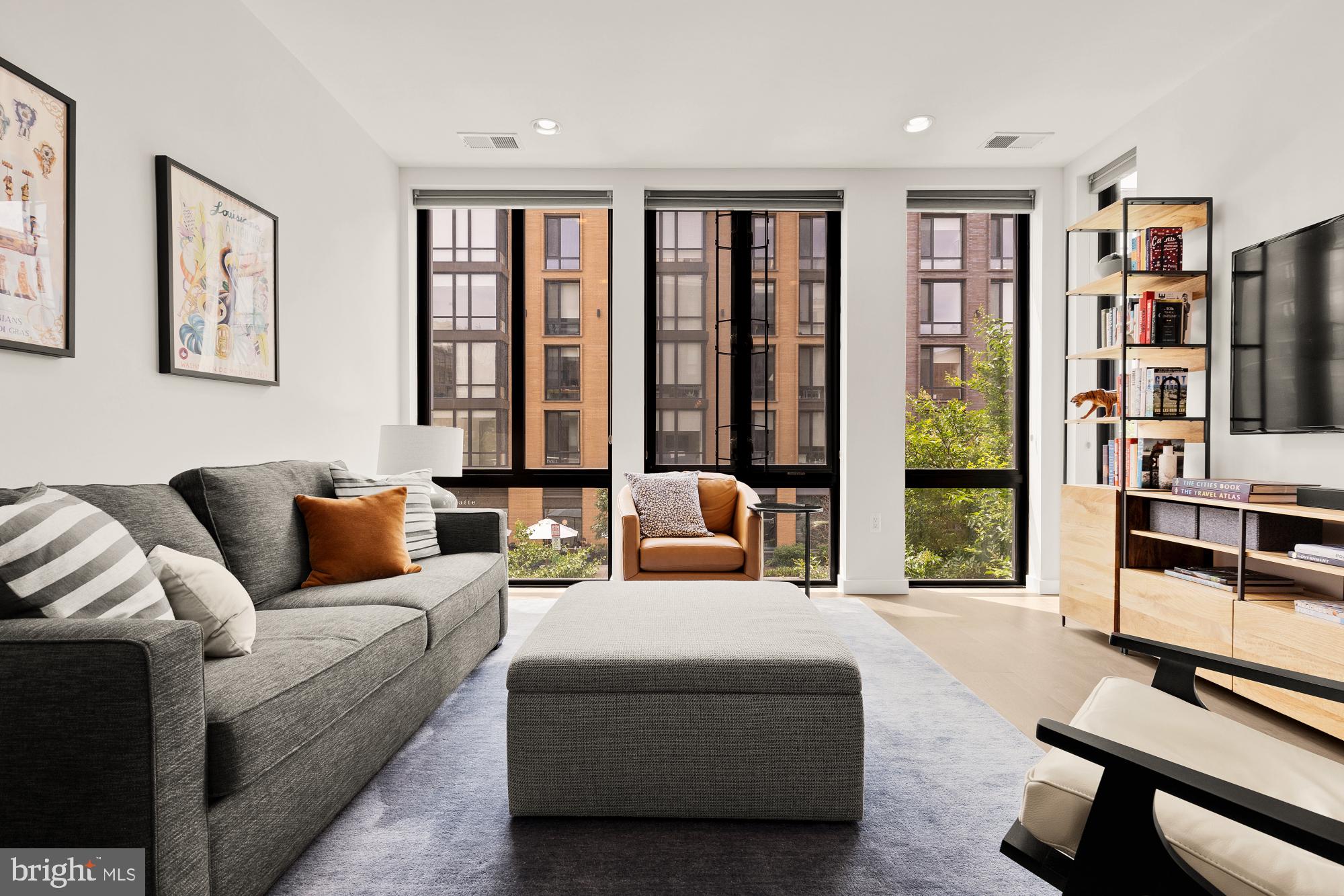 1405 W Street Northwest, Unit 203 Washington, DC 20009 - Photo 7 of 20 a living room with furniture a bookshelf and a window