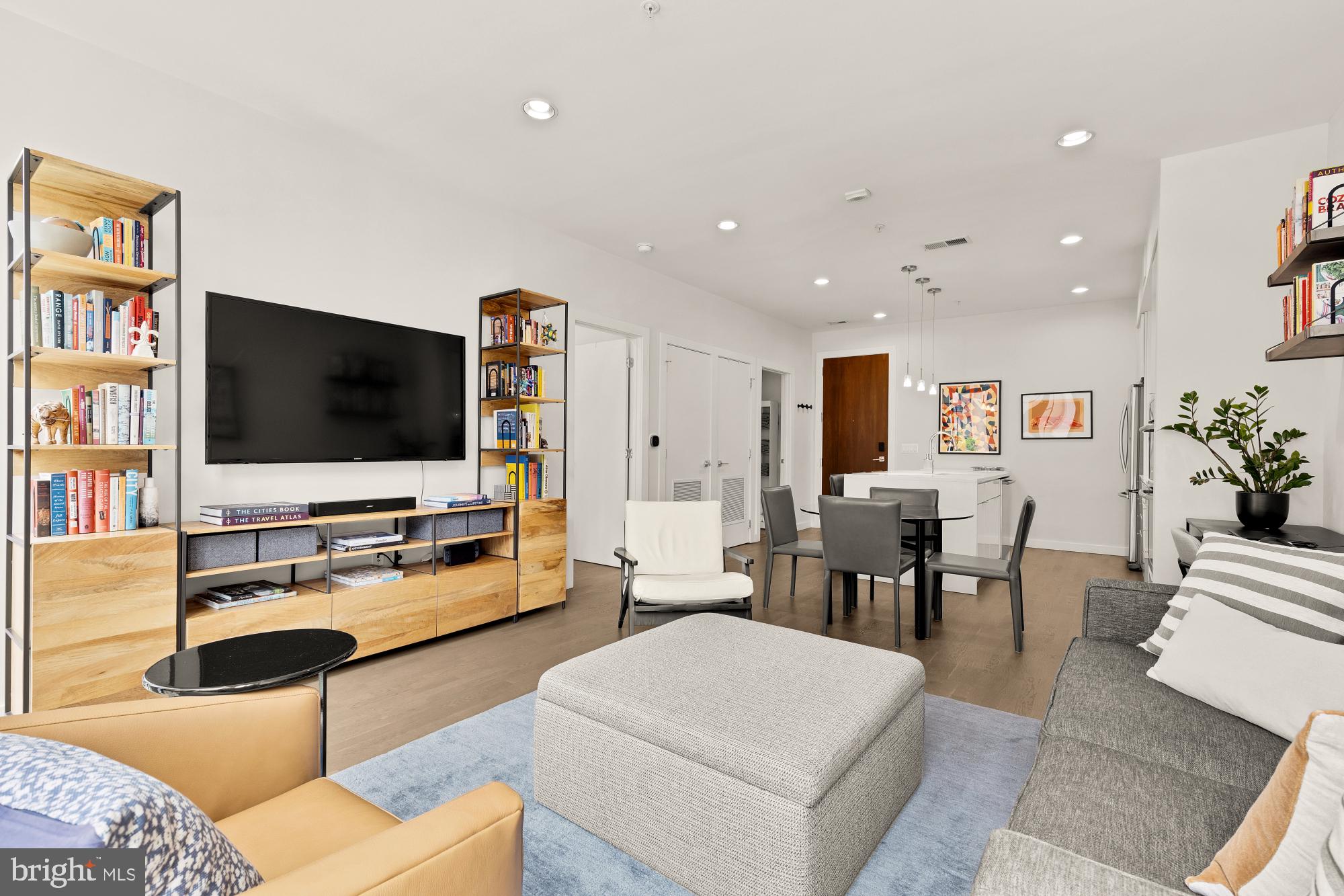 1405 W Street Northwest, Unit 203 Washington, DC 20009 - Photo 9 of 20 a living room with furniture and a flat screen tv