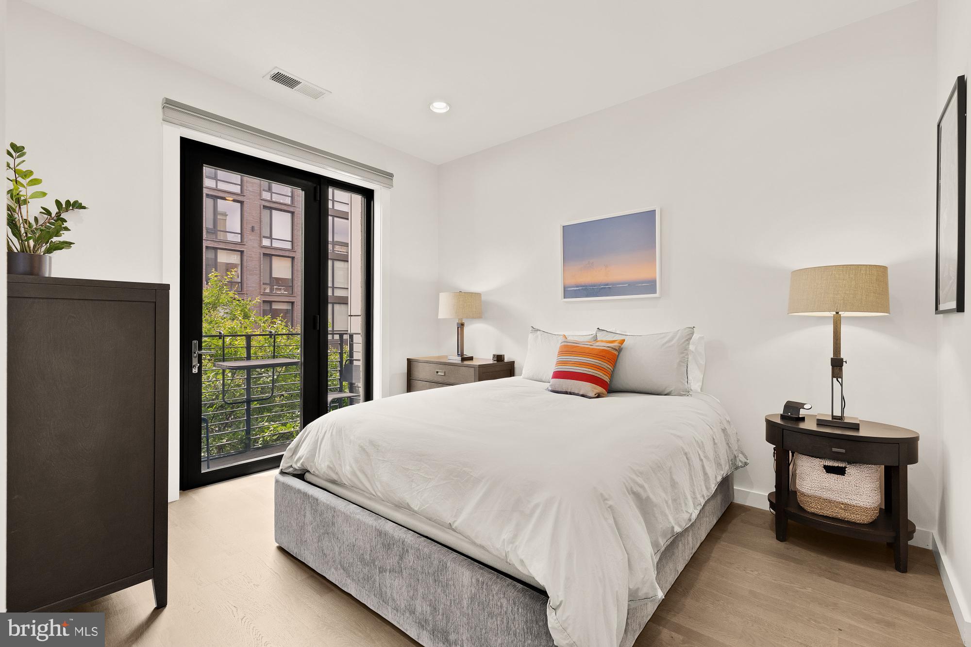 1405 W Street Northwest, Unit 203 Washington, DC 20009 - Photo 10 of 20 a bedroom with a bed and a window