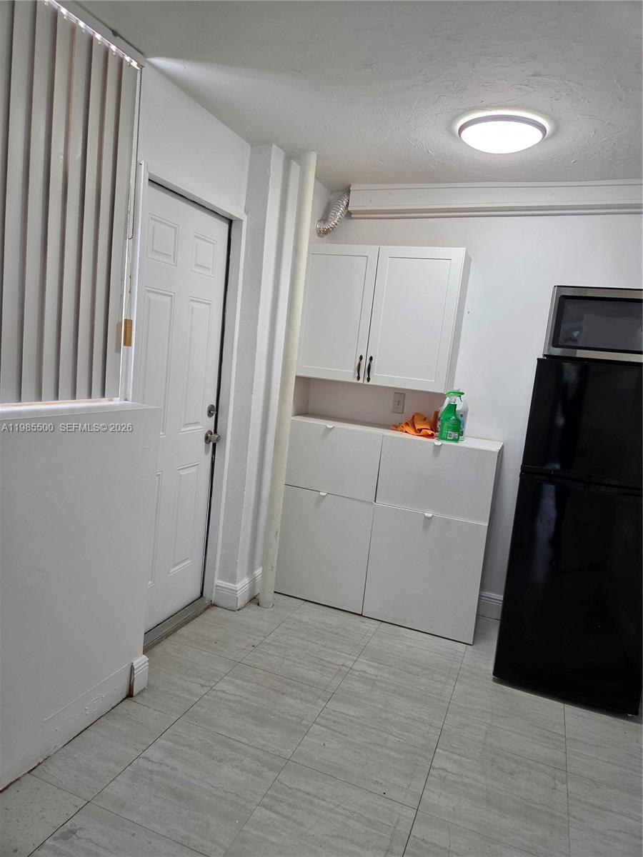 29420 Southwest 152nd Avenue, Unit 2 Homestead, FL 33033 - Photo 3 of 8 Small kitchen with refrigerator and gabinets