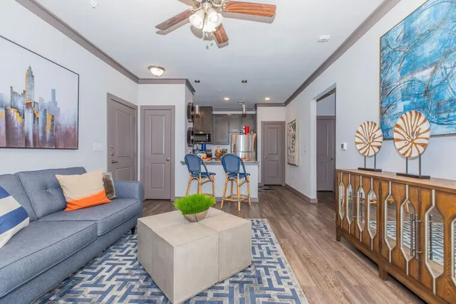 a living room with furniture and a wooden floor