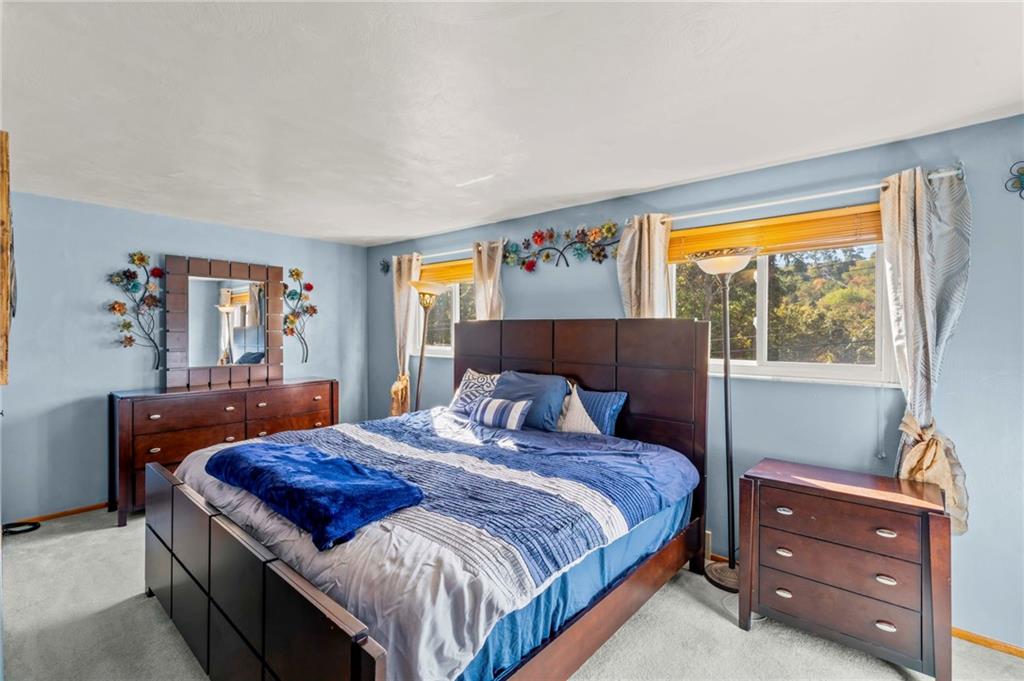 527 Pointview Road Pittsburgh, PA 15227 - Photo 12 of 25 a bedroom with a bed and wooden floor