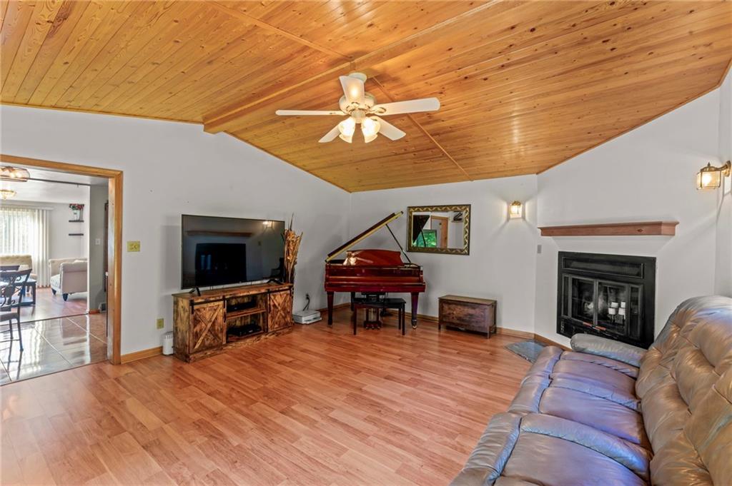 527 Pointview Road Pittsburgh, PA 15227 - Photo 5 of 25 a living room with furniture a fireplace and a flat screen tv