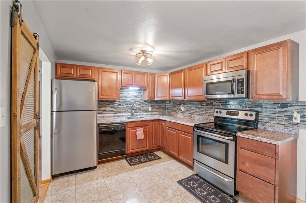 527 Pointview Road Pittsburgh, PA 15227 - Photo 6 of 25 a kitchen with stainless steel appliances granite countertop a refrigerator stove microwave and sink