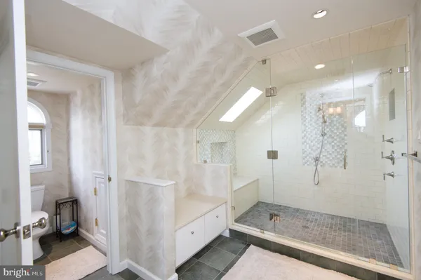 a bedroom with a bed and a a chandelier