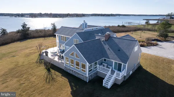 a kitchen with stainless steel appliances a sink dishwasher a stove top oven a sink with wooden floor and cabinets