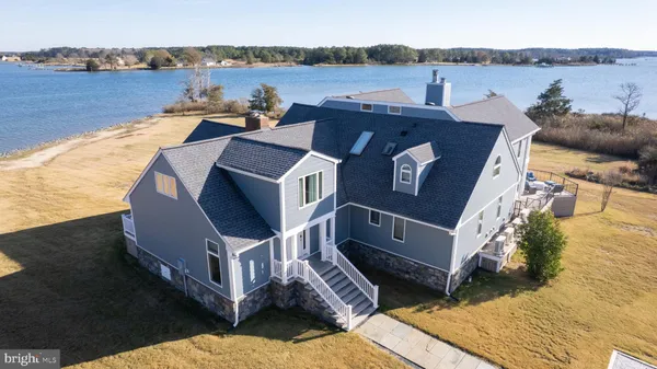 a dining hall with stainless steel appliances kitchen island granite countertop a refrigerator and a fireplace