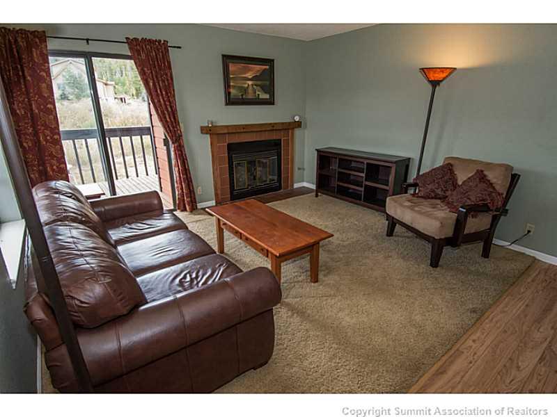 570 Bills Ranch Road, Unit A165 Frisco, CO 80443 - Photo 1 of 23 a living room with furniture and a fireplace