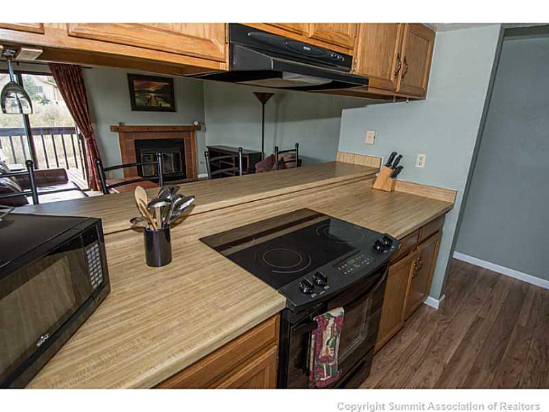 570 Bills Ranch Road, Unit A165 Frisco, CO 80443 - Photo 2 of 23 a kitchen with stainless steel appliances granite countertop a sink a stove and a microwave