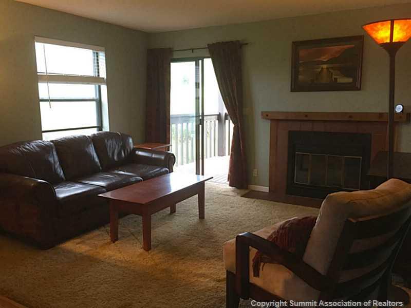 570 Bills Ranch Road, Unit A165 Frisco, CO 80443 - Photo 20 of 23 a living room with furniture a window and a fireplace