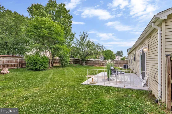a view of a chair and table in the backyard