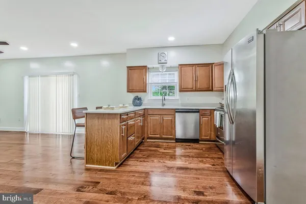 a kitchen with stainless steel appliances granite countertop a sink counter space and cabinets