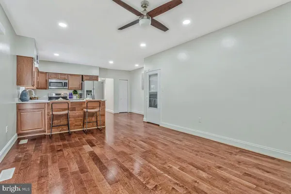 a kitchen with a refrigerator and a table