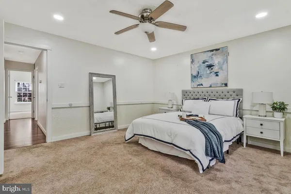 a spacious bedroom with a bed and a chandelier