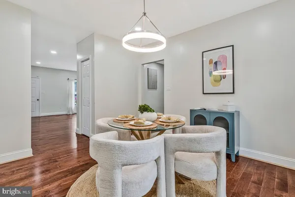 a dining room with furniture and wooden floor