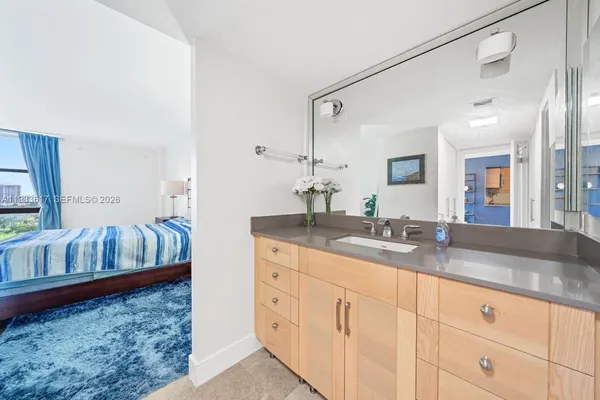 a bathroom with double vanity sink and a mirror