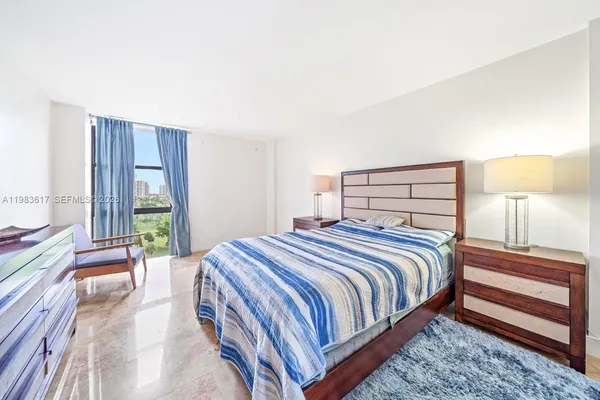 a bedroom with a bed and a potted plant