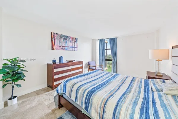 a bedroom with a bed and a potted plant