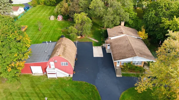 an aerial view of a house with garden space and street view