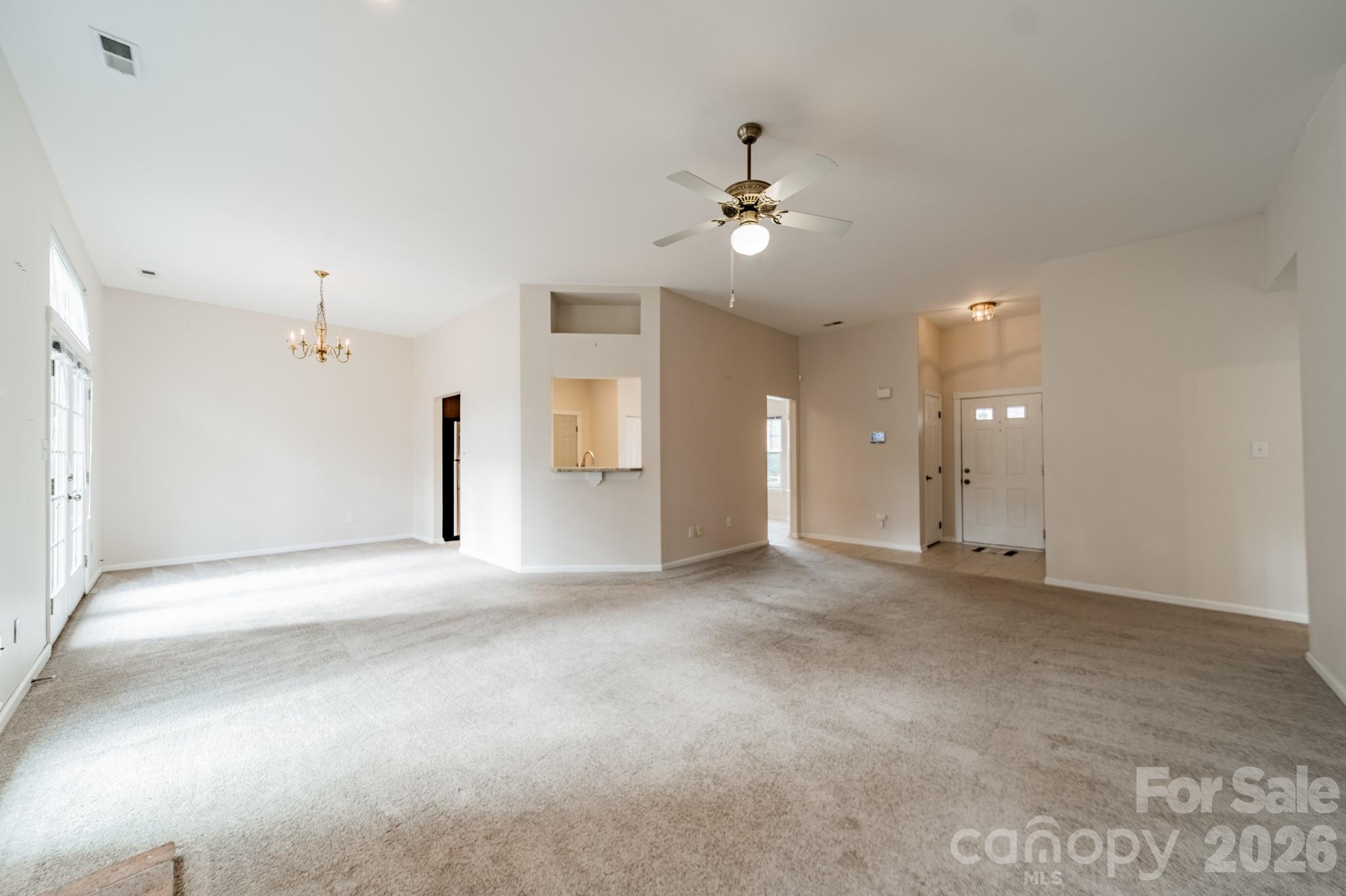 9409 Cedar River Road Huntersville, NC 28078 - Photo 11 of 31 en empty room with windows and ceiling fan